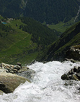 Crossing of a wild river. Far below, the Lac Bleu